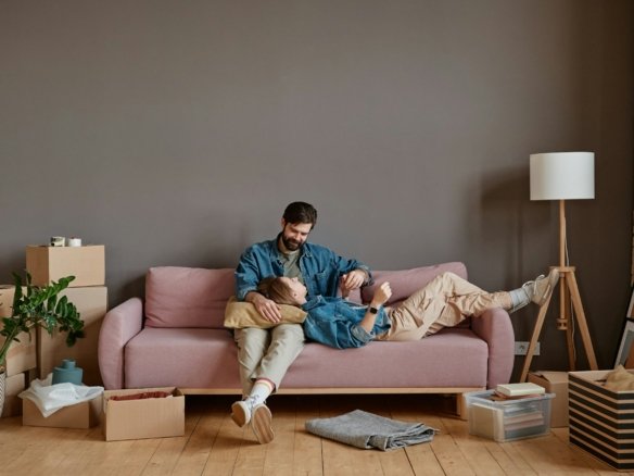 Couple Relaxing In New Apartment